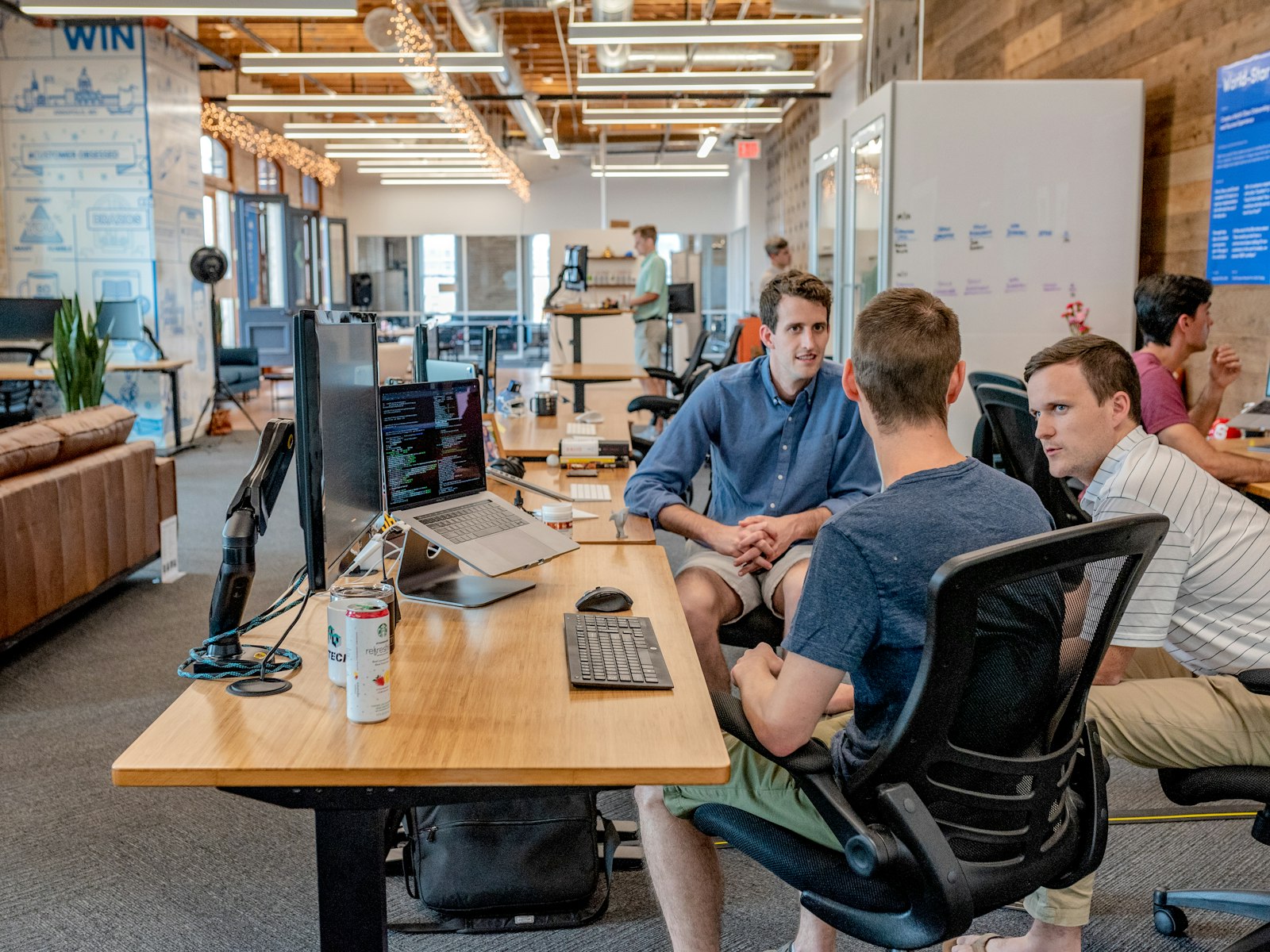 Team collaborating around laptops in a modern office