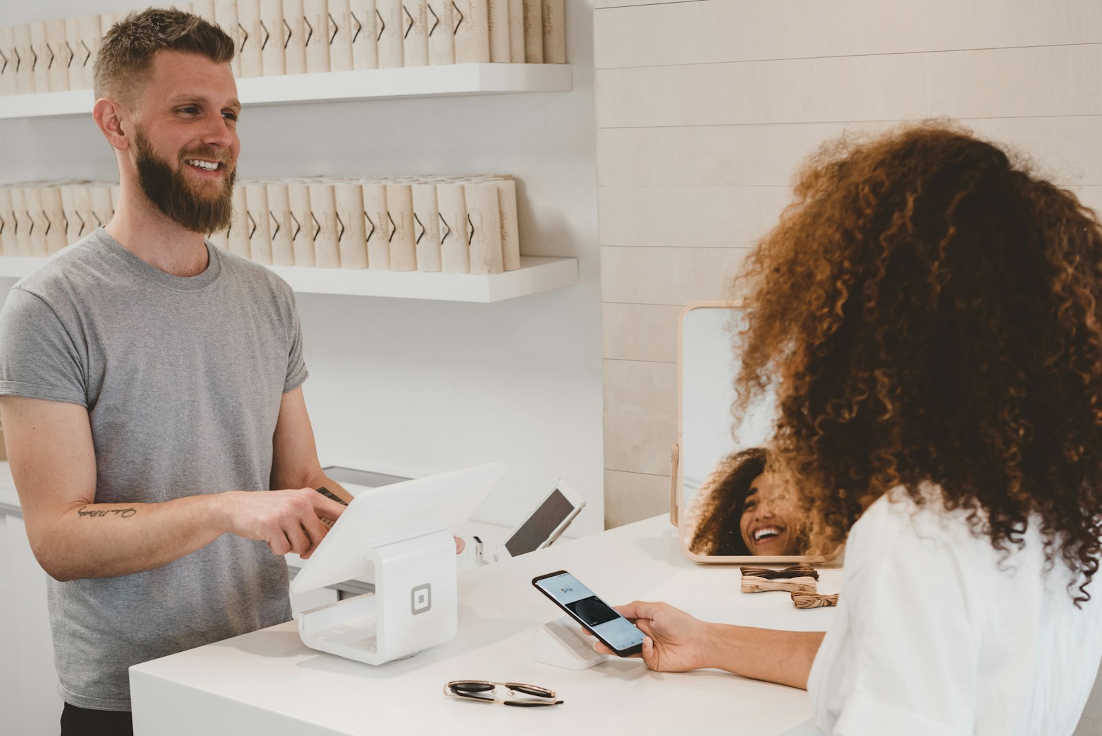 Retail checkout with a smiling customer